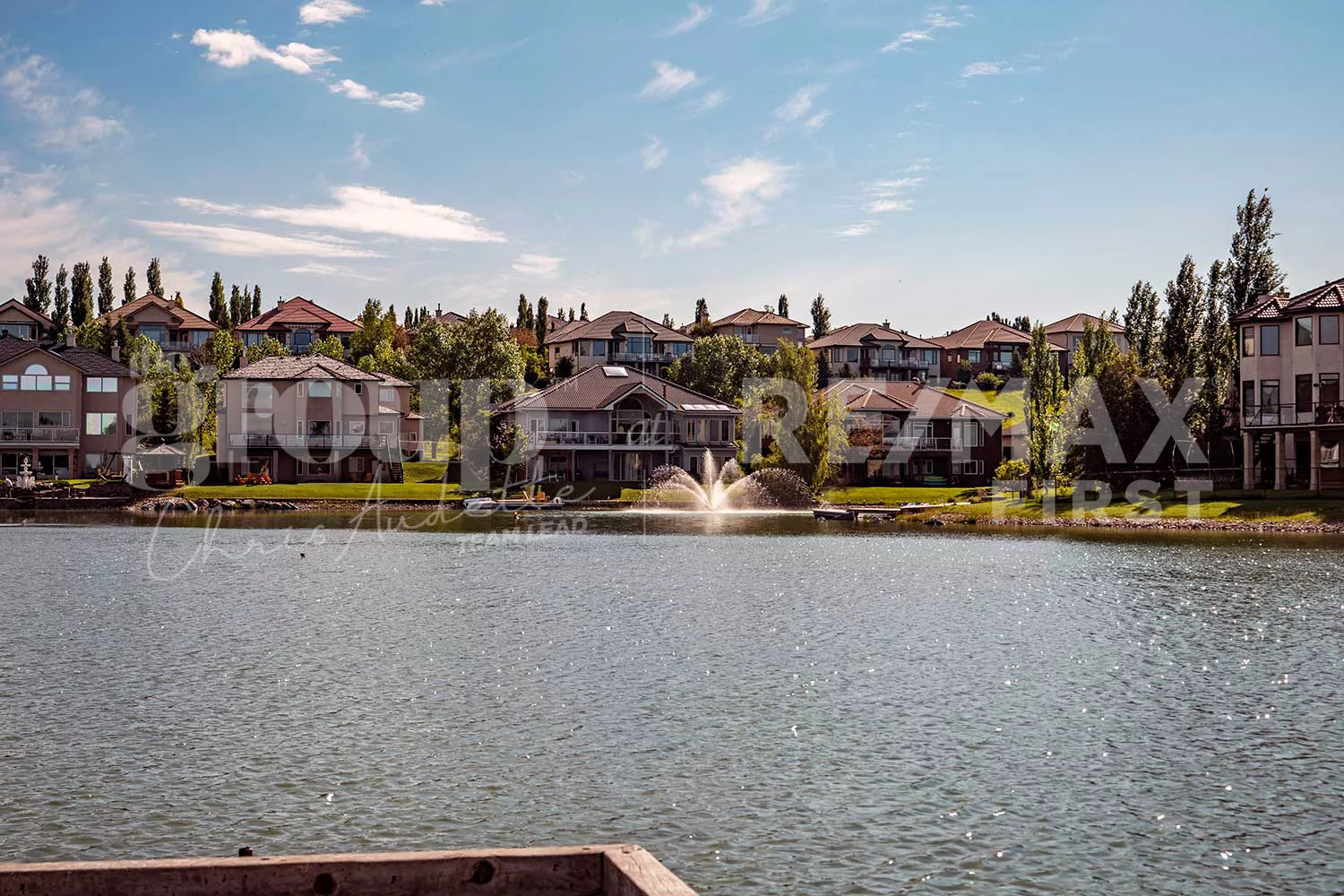 Across the lake view of residential homes in Arbour Lake